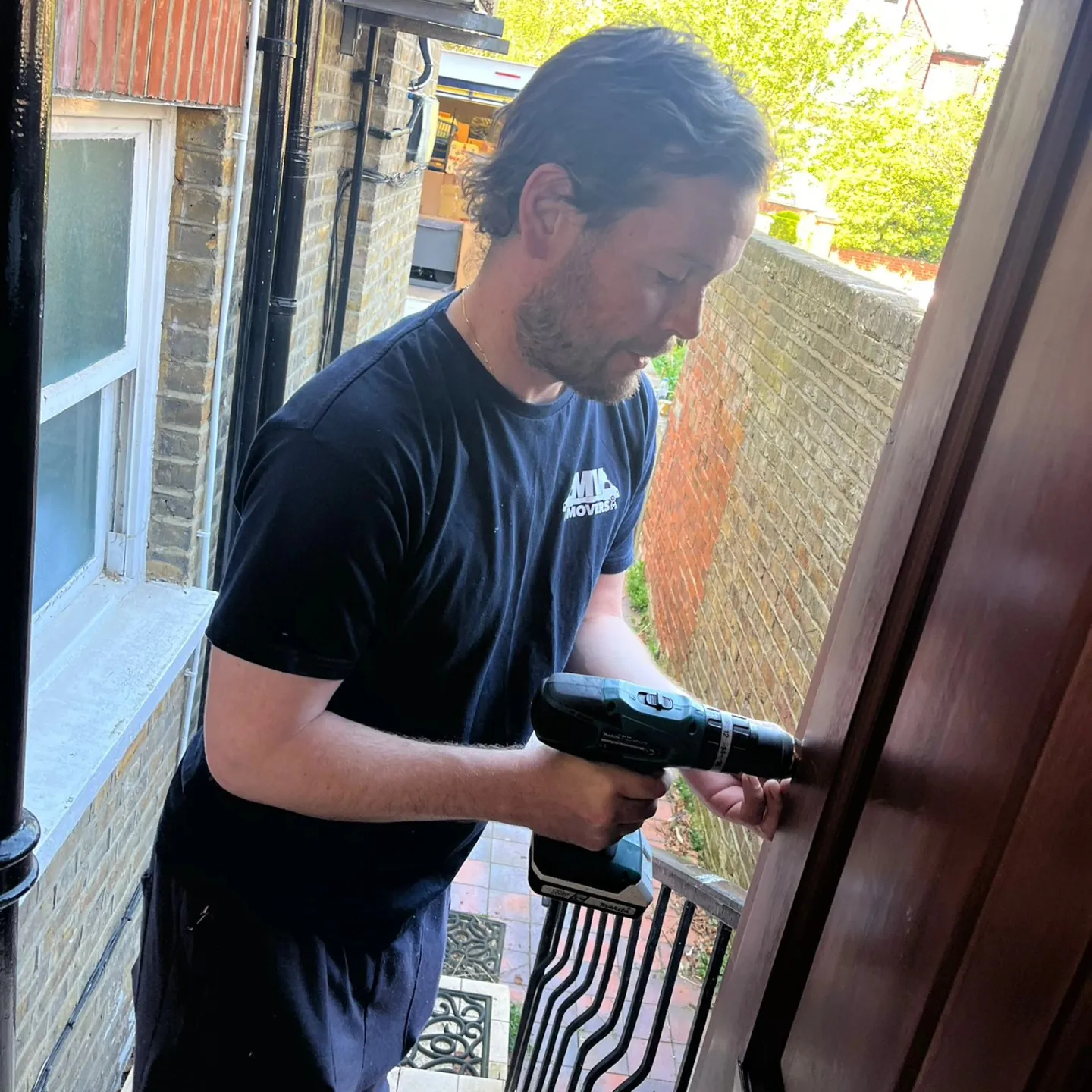 MV Movers crew member with a drill reassembling furniture – Furniture Assembly West London